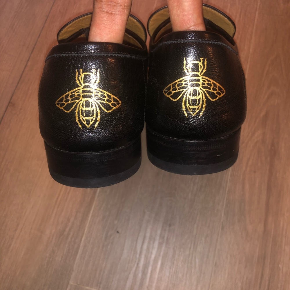 Gucci leather fringe horsebit loafers with golden bee on the back of the shoe.
